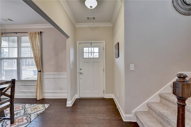 entrance foyer featuring ornamental molding, dark wood-type flooring, and a wealth of natural light