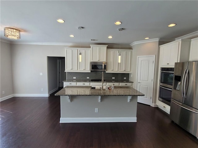 kitchen featuring white cabinets, a kitchen island with sink, stainless steel appliances, and dark hardwood / wood-style flooring