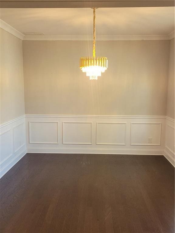 empty room with crown molding and dark wood-type flooring