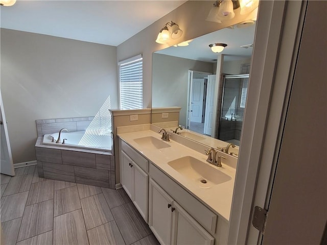 bathroom with vanity and separate shower and tub