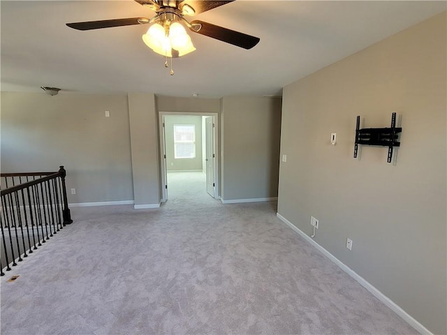 empty room featuring light colored carpet and ceiling fan