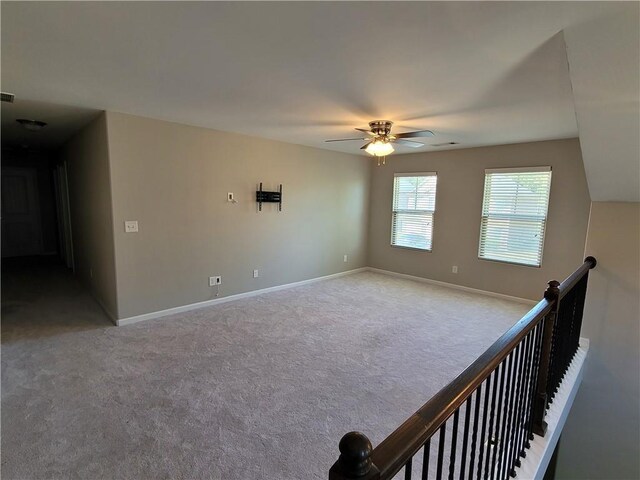 carpeted empty room with ceiling fan