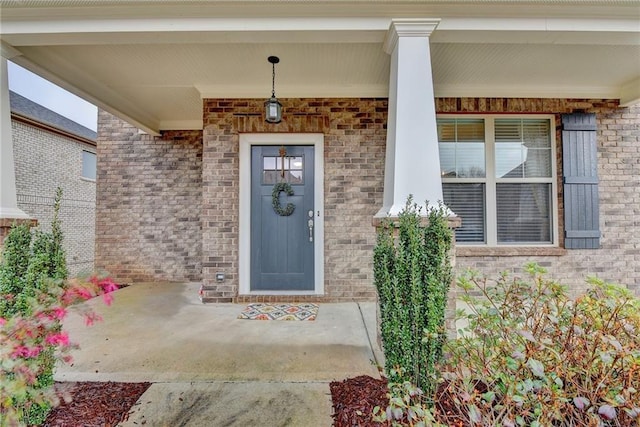 view of exterior entry with a porch