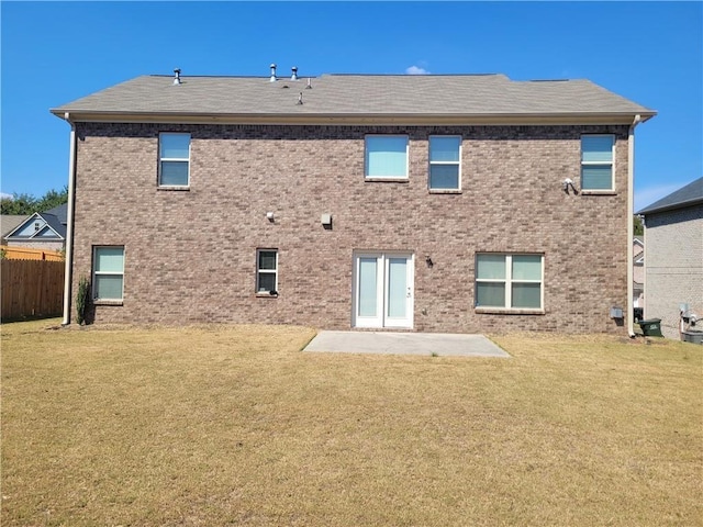 back of property featuring a yard and a patio area