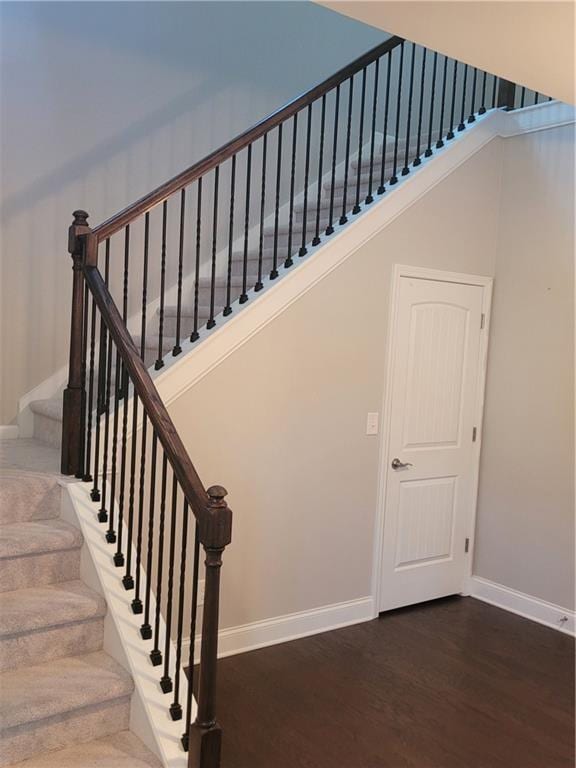 stairway with hardwood / wood-style floors