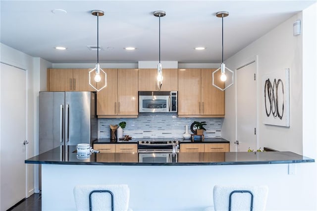 kitchen with backsplash, decorative light fixtures, a kitchen breakfast bar, and stainless steel appliances