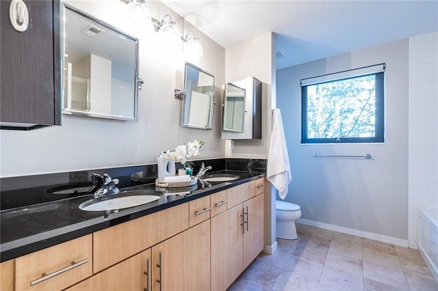 bathroom featuring tile patterned flooring, vanity, and toilet