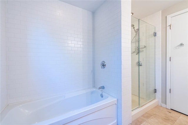 bathroom featuring tile patterned flooring and independent shower and bath