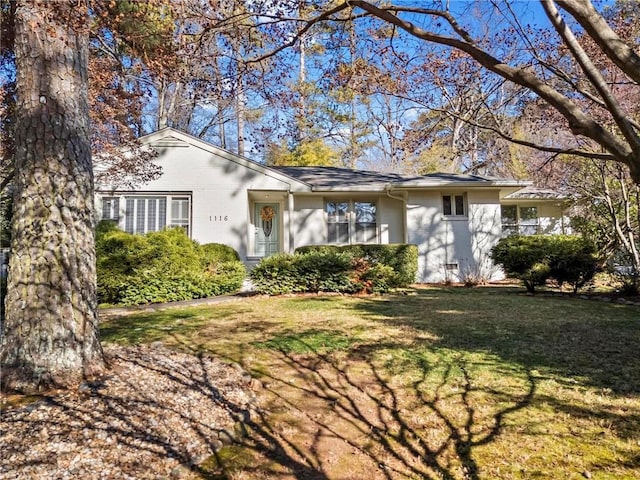 ranch-style home with a front lawn