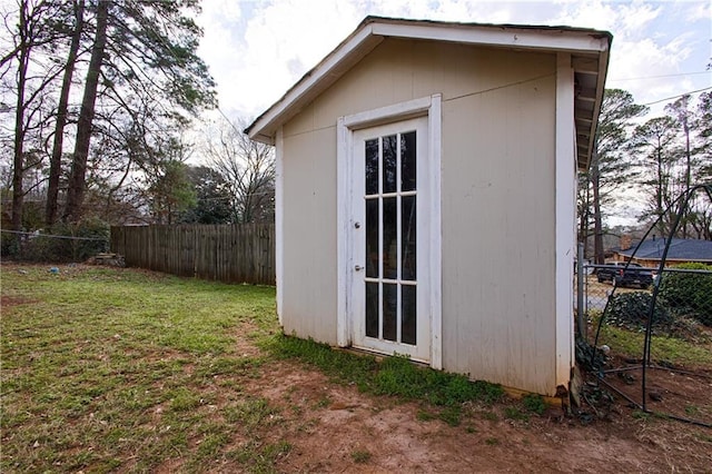 view of outbuilding featuring an outdoor structure and fence