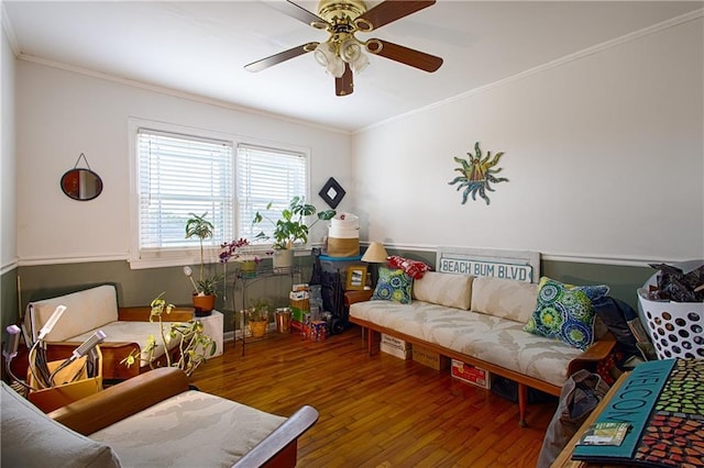 living area featuring ceiling fan, wood finished floors, and ornamental molding