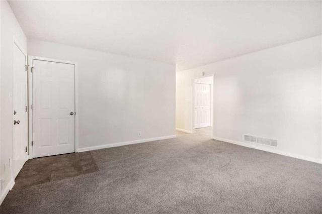 empty room with dark colored carpet
