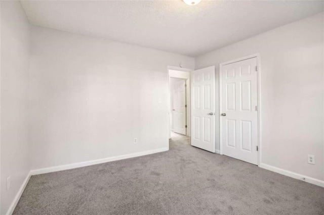 unfurnished bedroom featuring carpet flooring and a closet