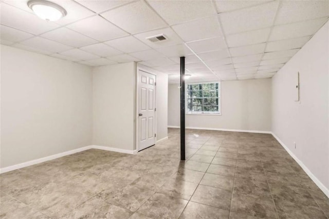 basement featuring a paneled ceiling