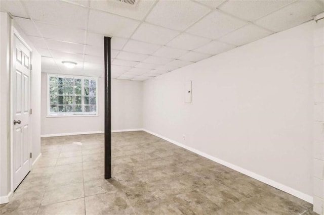 basement featuring a paneled ceiling