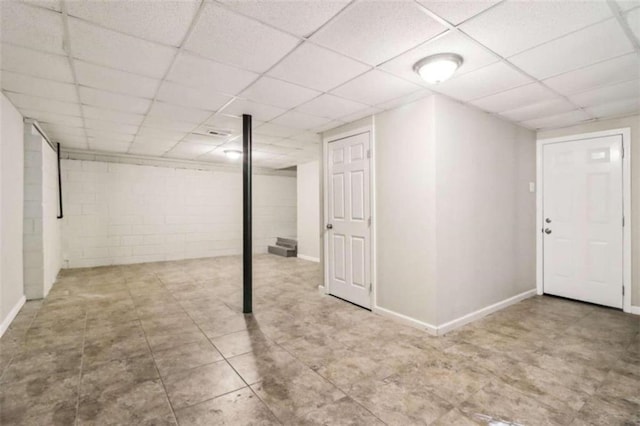 basement featuring a drop ceiling