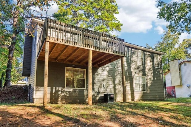 rear view of house with a wooden deck and cooling unit
