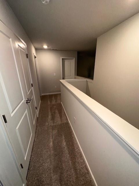 30 Barton Ln, Covington, GA 30016 - corridor featuring dark colored carpet, recessed lighting, baseboards, and an upstairs landing
