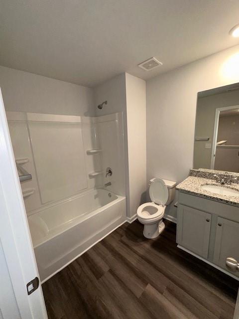 30 Barton Ln, Covington, GA 30016 - full bathroom with toilet, wood finished floors, vanity, tub / shower combination, and baseboards