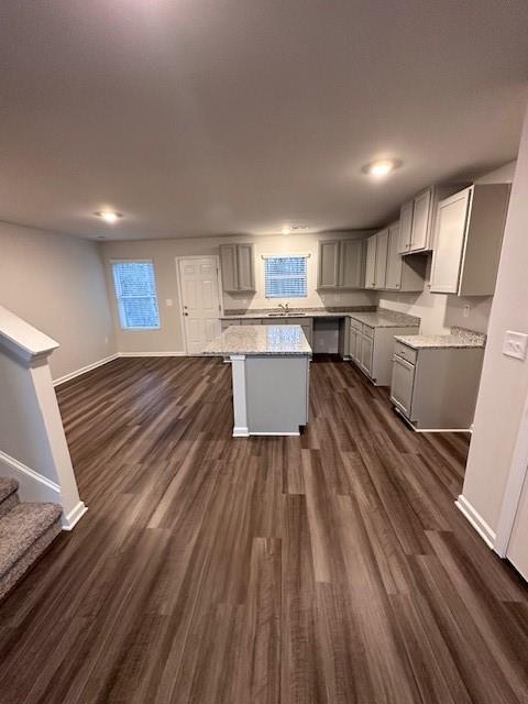 30 Barton Ln, Covington, GA 30016 - kitchen with gray cabinetry, a kitchen island, baseboards, dark wood finished floors, and recessed lighting