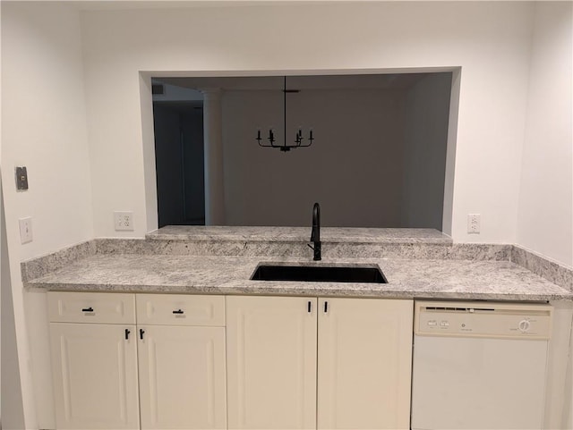 kitchen with dishwasher, white cabinetry, light stone countertops, and sink