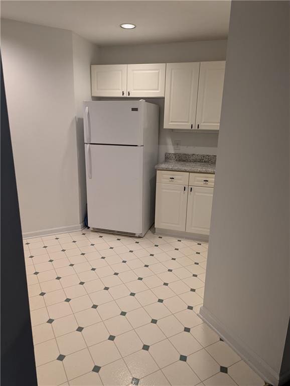 kitchen with white cabinets and white fridge