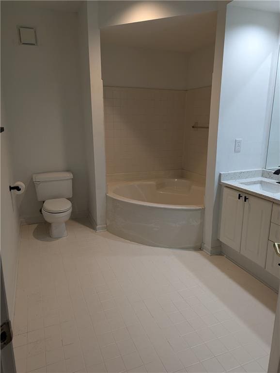 bathroom featuring a tub to relax in, tile patterned floors, vanity, and toilet