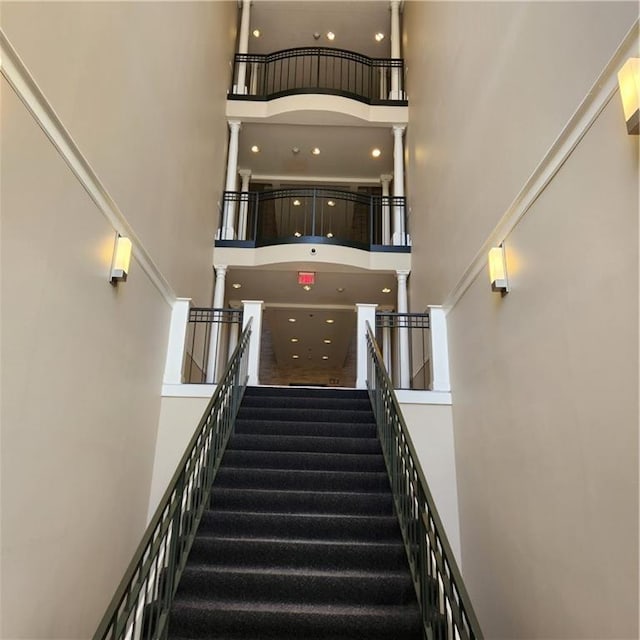 stairs featuring a high ceiling