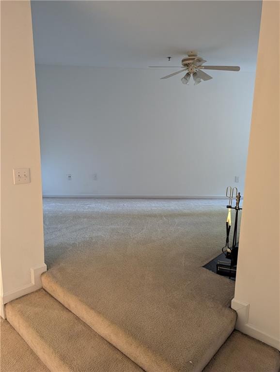 interior space featuring carpet flooring and ceiling fan