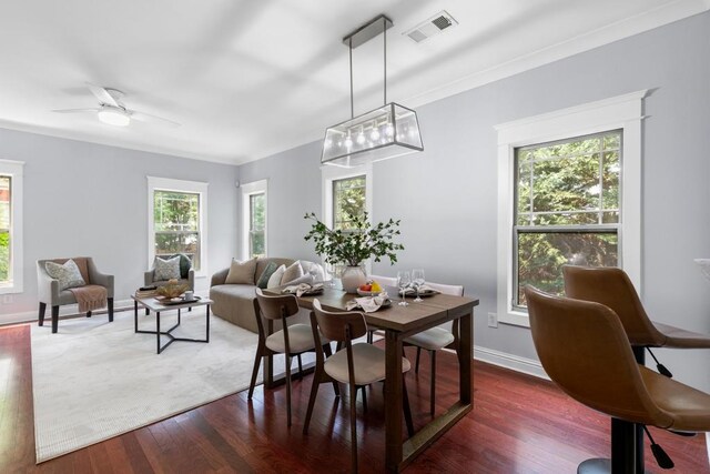 dining area featuring visible vents, baseboards, ceiling fan, and wood finished floors