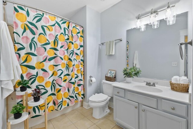 bathroom featuring vanity, tile patterned flooring, and toilet