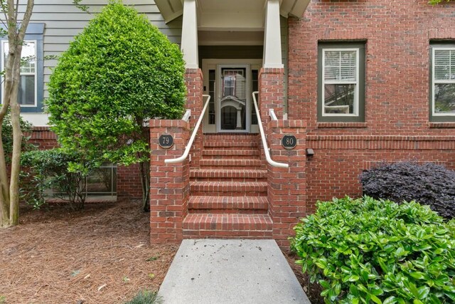 property entrance with brick siding