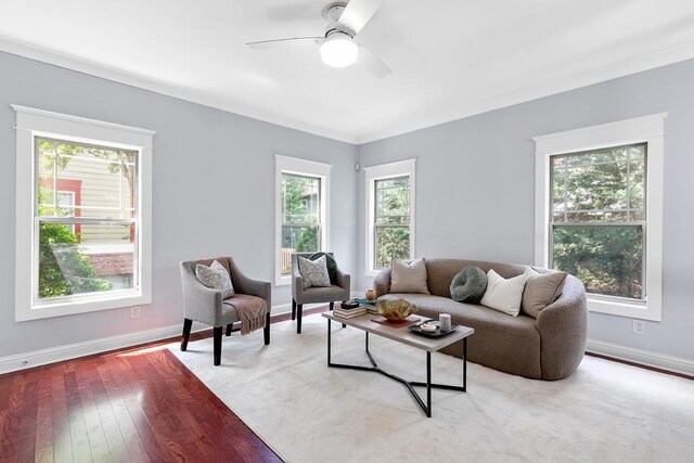 living area with plenty of natural light, baseboards, and ceiling fan