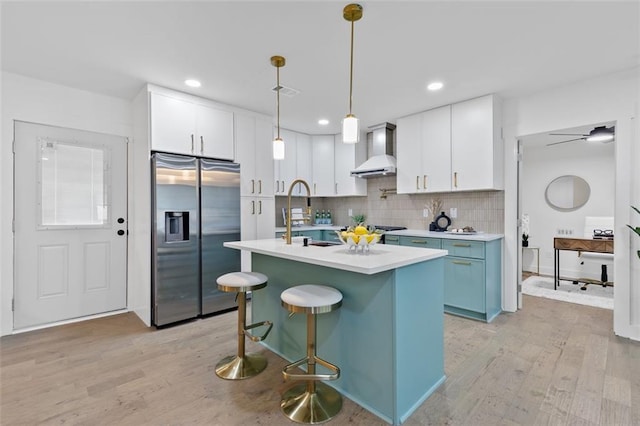 1643 Flintwood Dr SE, Atlanta, GA 30316 - kitchen featuring stainless steel fridge, wall chimney exhaust hood, a sink, light wood-type flooring, and recessed lighting