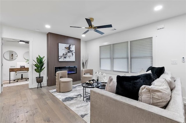 1643 Flintwood Dr SE, Atlanta, GA 30316 - living room with wood finished floors, ceiling fan, recessed lighting, and a glass covered fireplace