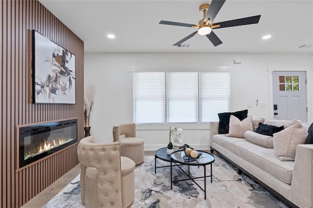 1643 Flintwood Dr SE, Atlanta, GA 30316 - living area featuring a glass covered fireplace, recessed lighting, wood finished floors, and ceiling fan