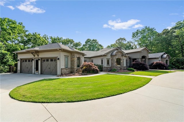 1447 Travis Smith Rd, Clarkesville, GA 30523 - view of front of house featuring a front yard, concrete driveway, an attached garage, and stone siding