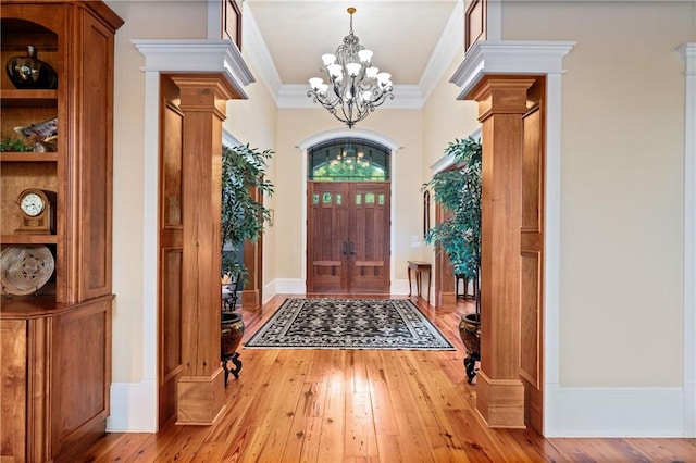 1447 Travis Smith Rd, Clarkesville, GA 30523 - entrance foyer featuring hardwood / wood-style flooring, a chandelier, ornamental molding, and ornate columns