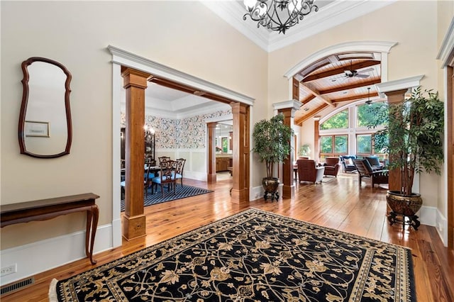 1447 Travis Smith Rd, Clarkesville, GA 30523 - entryway with decorative columns, a chandelier, hardwood / wood-style flooring, crown molding, and ceiling fan