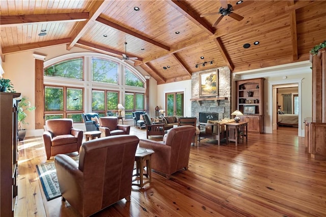 1447 Travis Smith Rd, Clarkesville, GA 30523 - living area featuring ceiling fan, wooden ceiling with exposed beams, a fireplace, hardwood / wood-style floors, and high vaulted ceiling