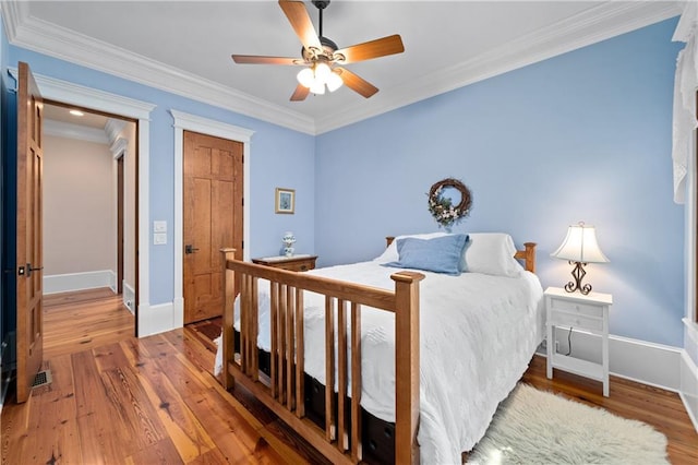 1447 Travis Smith Rd, Clarkesville, GA 30523 - bedroom featuring baseboards, wood finished floors, crown molding, and a ceiling fan