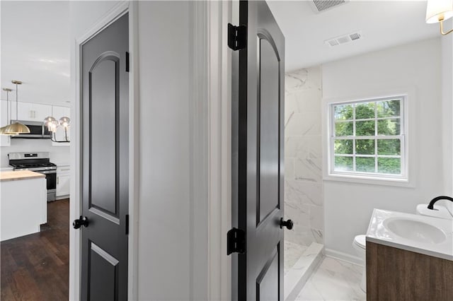 full bath with a shower, marble finish floor, visible vents, and vanity