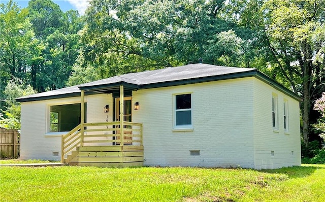 view of front of property featuring crawl space, a front lawn, and brick siding