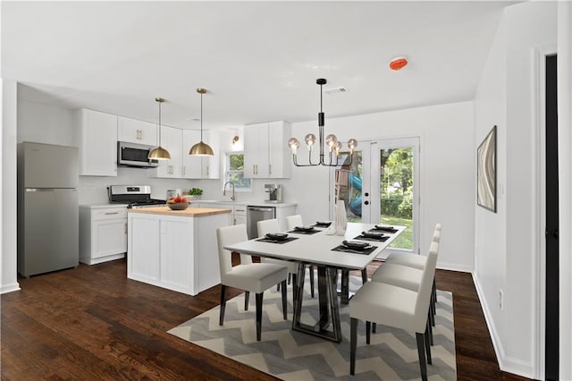 dining area with an inviting chandelier, visible vents, baseboards, and dark wood-type flooring