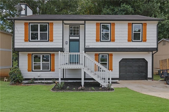 bi-level home with a garage and a front lawn