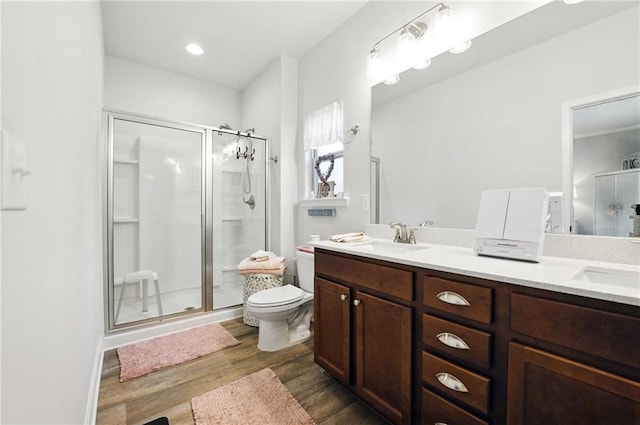 745 Skyview Dr, Commerce, GA 30529 - bathroom with a shower stall, wood finished floors, toilet, and double vanity