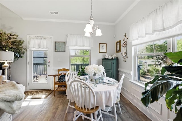 745 Skyview Dr, Commerce, GA 30529 - dining area with a chandelier, wood finished floors, ornamental molding, and a wainscoted wall