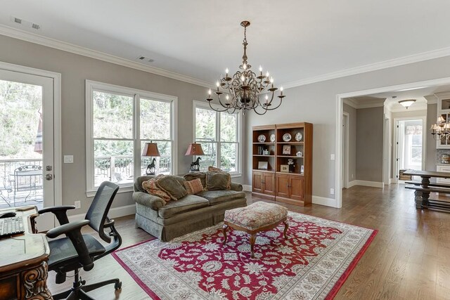 office area with wood finished floors, visible vents, crown molding, baseboards, and a notable chandelier