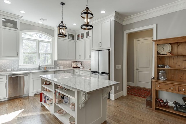 kitchen featuring white cabinetry, light wood-style floors, crown molding, open shelves, and appliances with stainless steel finishes