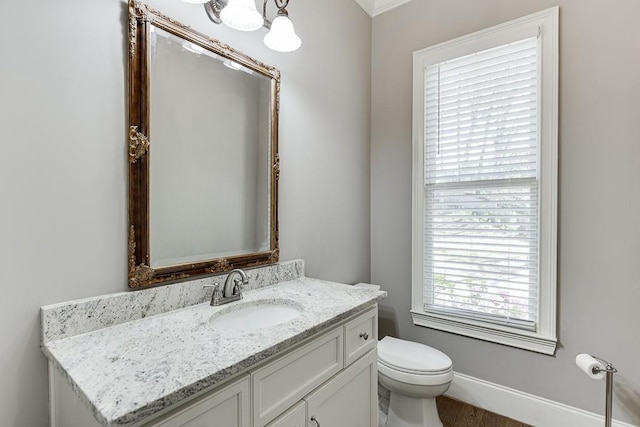 half bath featuring toilet and vanity